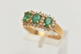 AN 18CT GOLD EMERALD AND DIAMOND RING, designed as three claw set, oval cut emeralds, heavily