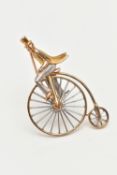 A 9CT GOLD PENNY FARTHING BROOCH, a white and yellow gold gentleman riding a penny farthing bicycle,