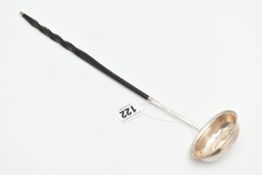 A WHITE METAL LADLE, set with a worn silver coin to the base, fitted with an ebonised handle (