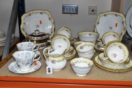 A TUSCAN CHINA HAND PAINTED TEA SET, pattern number 7936, pale lemon and gilt border decorated