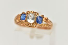 A LATE VICTORIAN THREE STONE RING, set with a principal rock crystal, one garnet topped doublet