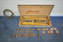 A VINTAGE CROQUET SET, in a wooden crate, comprising eight mallets, eight wooden balls, two pairs of