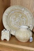 THREE PIECES OF CREAM ZSOLNAY 'OLD IVORY' WARES, comprising a charger with relief figural