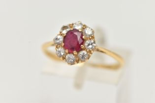 A YELLOW METAL RUBY AND DIAMOND CLUSTER RING, of a circular form, set with a central circular cut