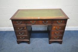 A 20TH CENTURY MAHOGANY PEDESTAL DESK, with a green tooled leather writing surface, fitted with an