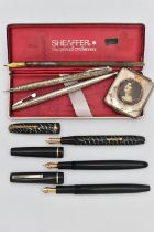 SIX PENS, to include a Sheaffer pen and retractable pencil set with engraved scrolling foliage