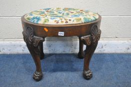 A REPRODUCTION OVAL WALNUT IRISH STOOL, with foliate drop in seat pad, on cabriole legs carved