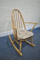 AN ERCOL BLONDE ELM AND BEECH QUAKER ROCKING CHAIR (condition report: general signs of usage, some