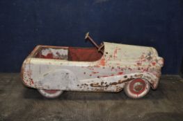 A 1950'S CHILDS TIN PLATE PEDAL CAR with distressed paint finish, total length 36in (Condition