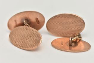 A PAIR OF EARLY 20TH CENTURY 9CT GOLD CUFFLINKS, each designed as two oval panels with engine turned