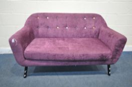 A PURPLE UPHOLSTERED TWO SEATER SOFA, with multi-coloured buttoned back, on cylindrical metal