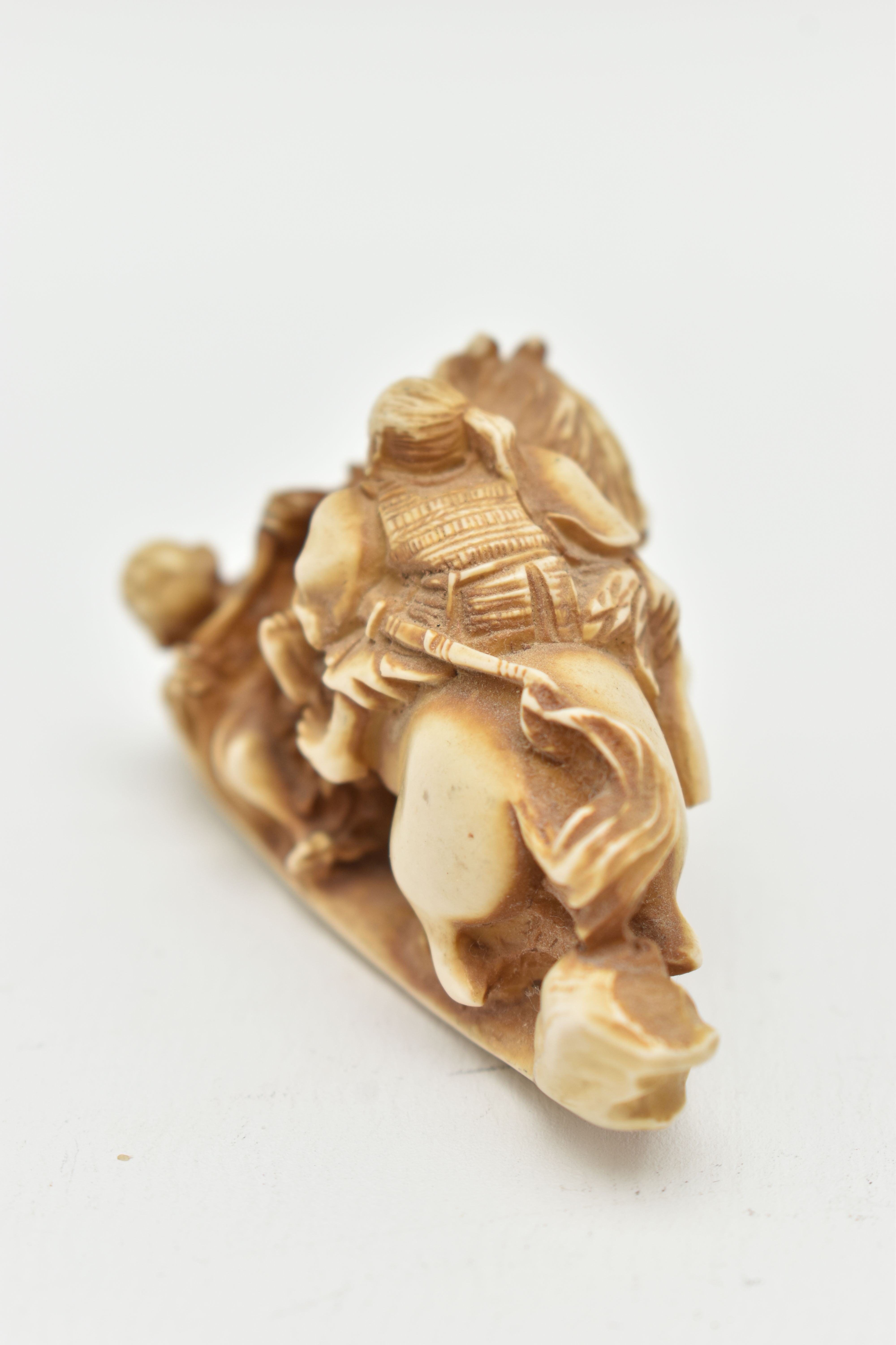 A BONE OKIMONO, a carved ornament depicting a man on a horse over a fallen down man, approximate - Image 4 of 7