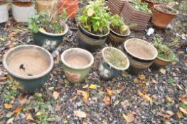 A SET OF EIGHT GREEN GLAZED PLANT POTS, of various sizes, including a set of four and a set of