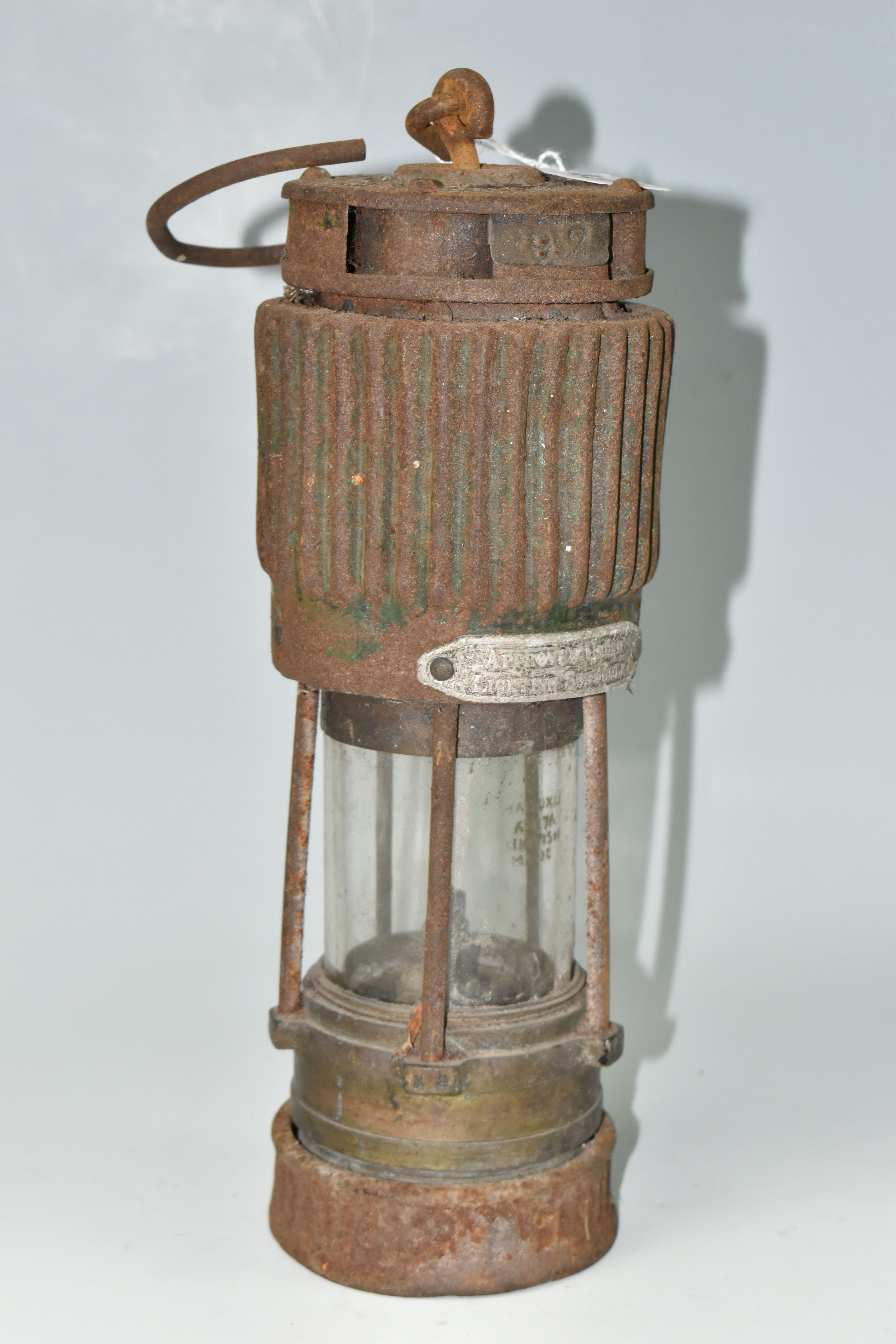 A VINTAGE PATTERSON TYPE MINER'S LAMP, in rusted condition, lettering to top indistinct, bears