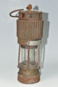A VINTAGE PATTERSON TYPE MINER'S LAMP, in rusted condition, lettering to top indistinct, bears
