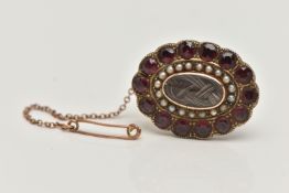 A LATE VICTORIAN MOURNING BROOCH, of an oval outline, plaited hair centre piece with glazed panel,
