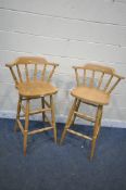 A PAIR OF TALL BEECH STOOLS, with spindled back rest, turned legs and stretchers, height 106cm (
