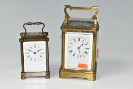 TWO EARLY 20TH CENTURY CARRIAGE CLOCKS, the larger with brass case, white enamel dial with Roman