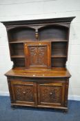 AN EARLY 20TH CENTURY OAK DRESSER, the top with a cupboard door, surrounded by shelving, the base
