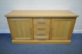 A HEAVY OAK SIDEBOARD, with four pine lined drawers, flanked by two cupboard doors, length 180cm x