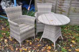 A DIAMOND DISTINCTION FAUX RATTAN CIRCULAR GARDEN TABLE AND CHAIRS, with cushions (condition report: