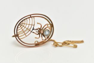 AN EARLY 20TH CENTURY SPIDER BROOCH, of an oval outline, featuring an open work spider web design
