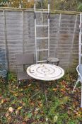 A MODERN CIRCULAR TILE TOP GARDEN TABLE, diameter 70cm x height 72cm, a folding faux rattan chair,