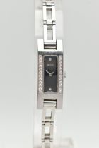 A GUCCI DIAMOND SET WRISTWATCH, the black rectangular dial signed 'Gucci Swiss Made', diamond dot