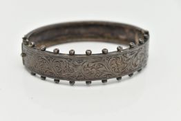 A MID CENTURY SILVER BANGLE, a Victorian style hinged bangle with etched foliage detail and