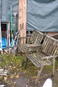 A PAIR OF WEATHERED TEAK GARDEN ARMCHAIRS, along with a selection of garden tools, including three