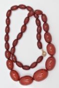 A BAKELITE BEAD NECKLACE, comprising of thirty-five graduated oval shape beads measuring