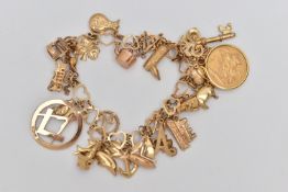 A CHARM BRACELET, the heart link bracelet suspending twenty-five charms, to include a mounted George