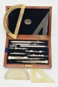 A BOXED TECHNICAL DRAWING SET, with geometric drawing instruments, a folding wooden and brass ruler,