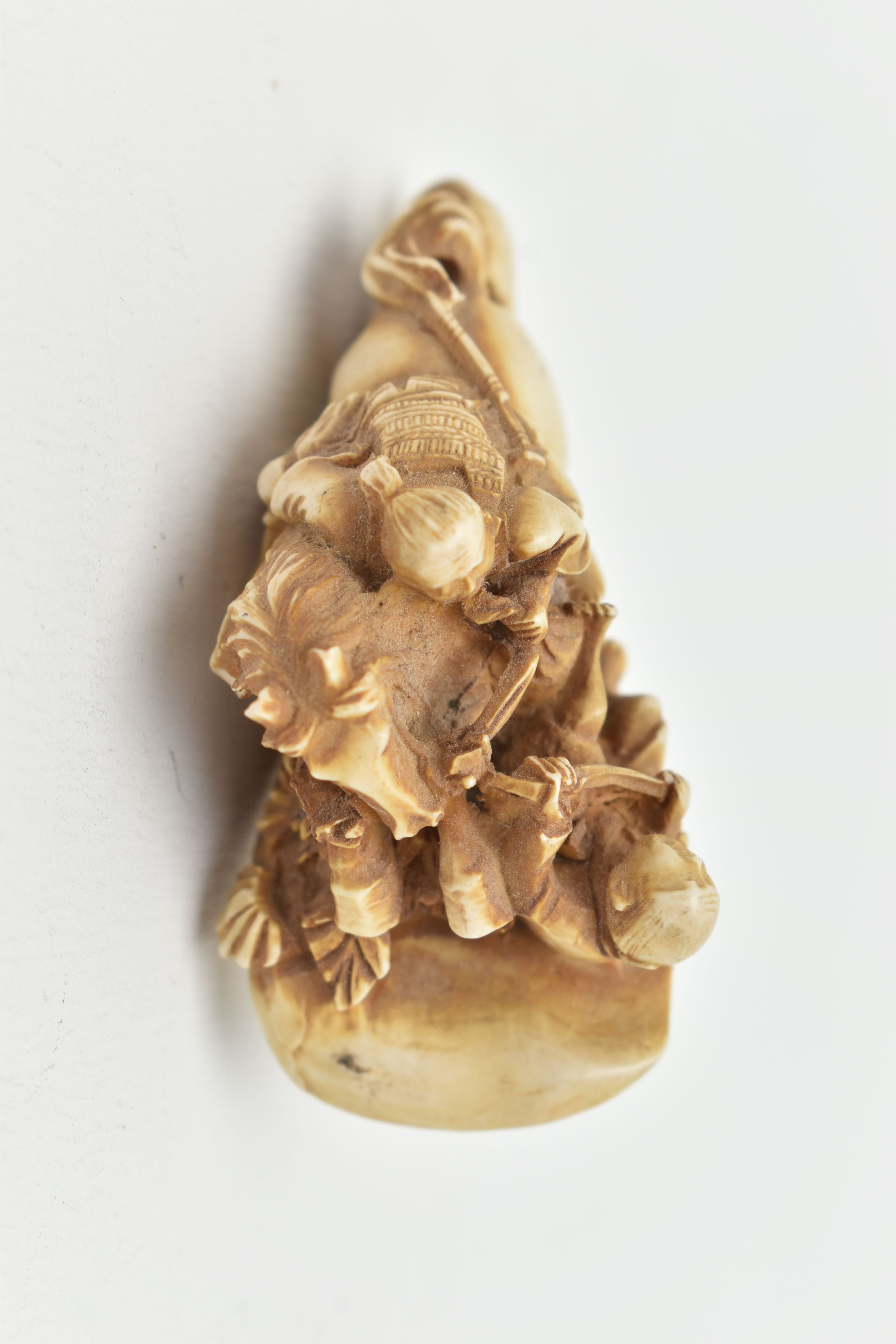 A BONE OKIMONO, a carved ornament depicting a man on a horse over a fallen down man, approximate - Image 7 of 7