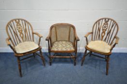 AN EARLY 20TH CENTURY OAK BERGÈRE BACK ARMCHAIR, with foliate upholstery, on turned supports and