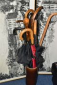 A GROUP OF WALKING STICKS, UMBRELLAS AND FRAMED PRINTS, to include four walking sticks - one with