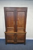A LARGE FRENCH OAK CABINET, with four doors, enclosing and arrangement of shelving, width 140cm x