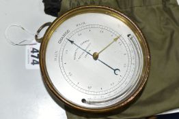 A NEGRETTI & ZAMBRA BRASS CASED CIRCULAR BAROMETER, the silvered dial marked with 'RAIN CHANGE