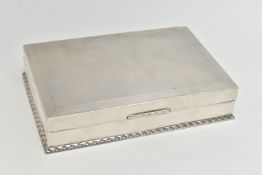 AN EARLY 20TH CENTURY SILVER CIGARETTE BOX, table top box, of a rectangular form, engine turned