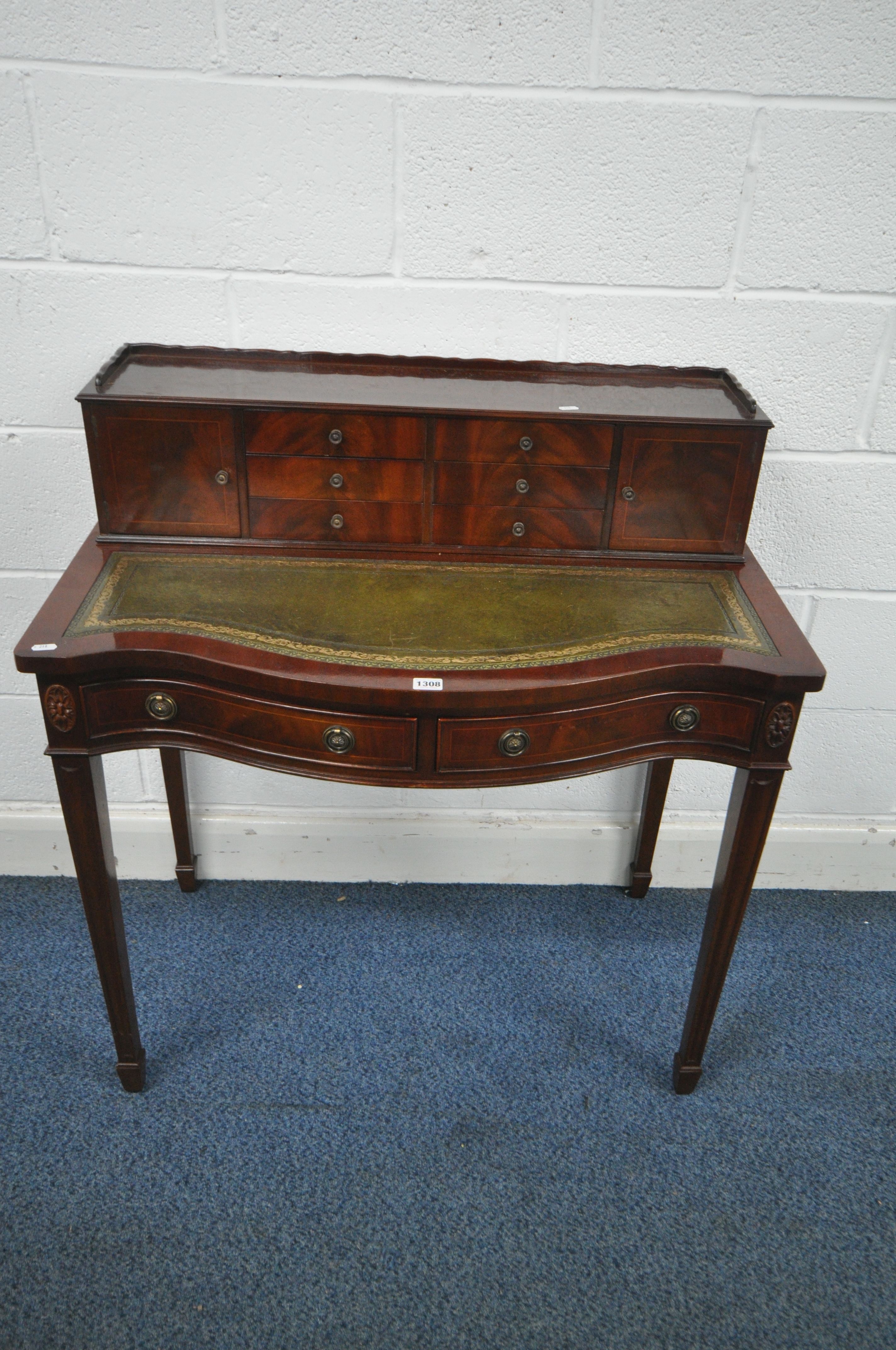 A 20TH CENTURY MAHOGANY BOW FRONT LADIES DESK, with a raised back, fitted with an arrangement of