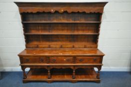 A THEODORE ALEXANDER HARDWOOD DRESSER, the top with a two tier plate rack and six small drawers, the
