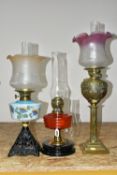 THREE LARGE VICTORIAN OIL LAMPS, comprising a cast pyramid shaped lamp base, with a blue custard