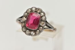 AN EARLY 20TH CENTURY GEM SET RING, designed as a central rectangular ruby within an old cut diamond
