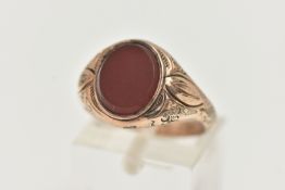 A GENTS SIGNET RING, of an oval form, set with an oval carnelian panel, collet set to the textured