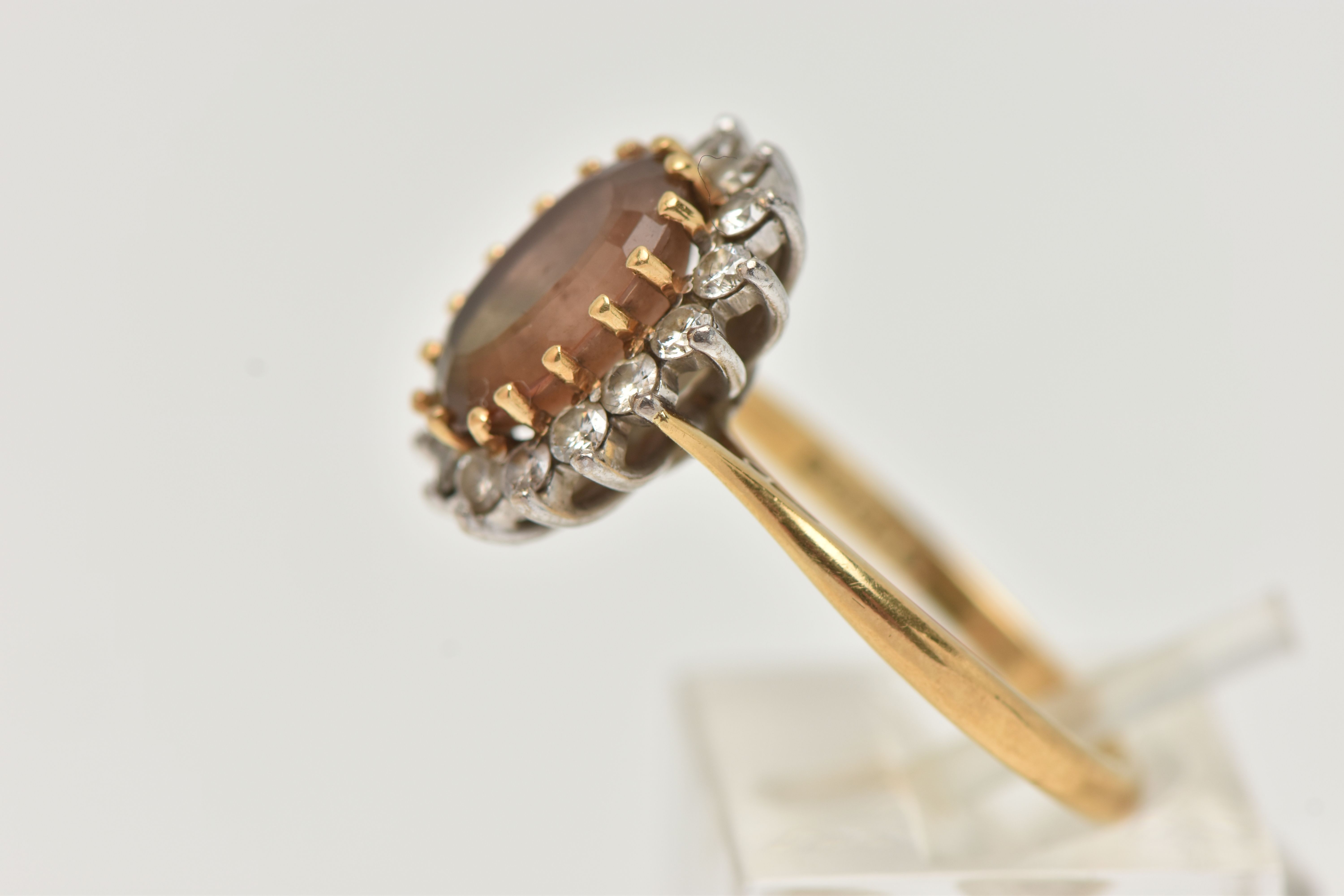AN 18CT GOLD SMOKY QUARTZ AND DIAMOND CLUSTER RING, the oval smoky quartz within a brilliant cut - Image 2 of 4