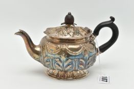 A LATE VICTORIAN SILVER BACHELORS TEA POT OF SQUAT CIRCULAR FORM, repoussé decorated to the domed