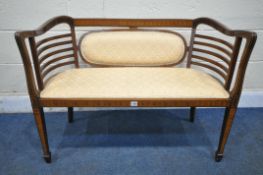 AN EDWARDIAN MAHOGANY AND INLAID SHERATON REVIVAL TWO SEATER SOFA, with shaped sides and armrests,