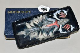 A BOXED MOORCROFT POTTERY RECTANGULAR PEN TRAY DECORATED IN THE SNAKESHEAD PATTERN, on a dark blue/