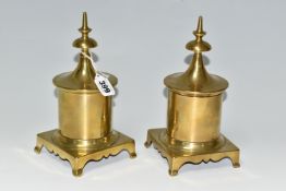 TWO BRASS TOBACCO JARS, with covers, the jars of cylindrical form supported on four feet, height