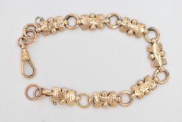 A LATE VICTORIAN BRACELET, the shaped links with engraved foliate design and beaded detail, to the